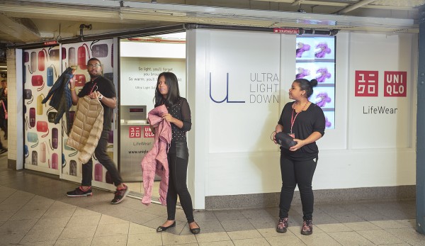 Uniqlo employees show off the merchandise available in the Union Square pop-up shop.