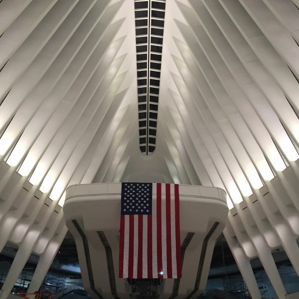 An American flag hangs over the half of the PATH Hub still closed to people. (Photo: Benjamin Kabak)